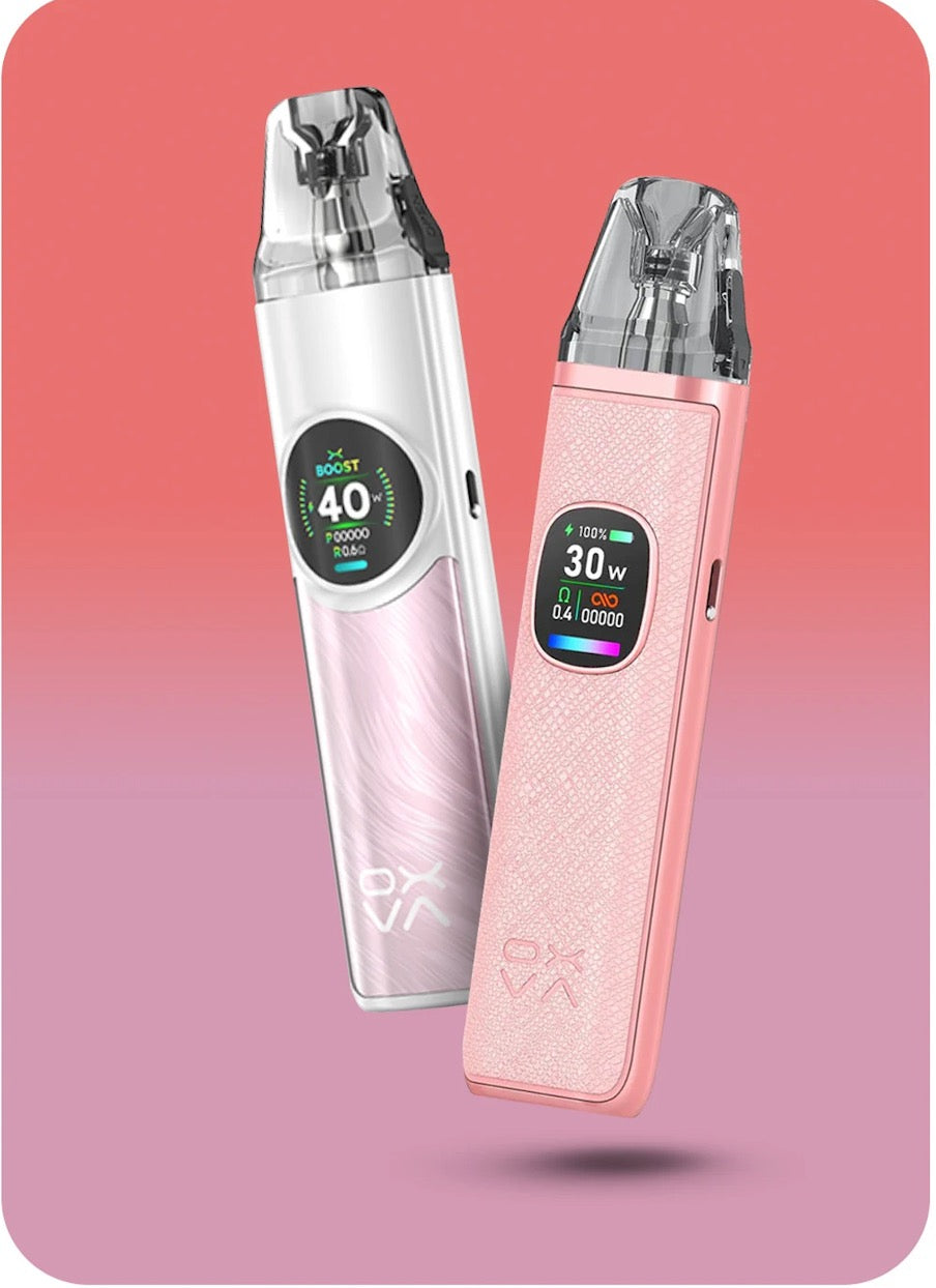 Two OXVA vaping devices, one silver and one pink, on a gradient pink background.